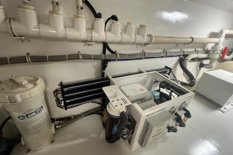 Sixpack Yacht Photos Pics Engine room of 2013 Hatteras GT63 yacht with water filtration system and piping.