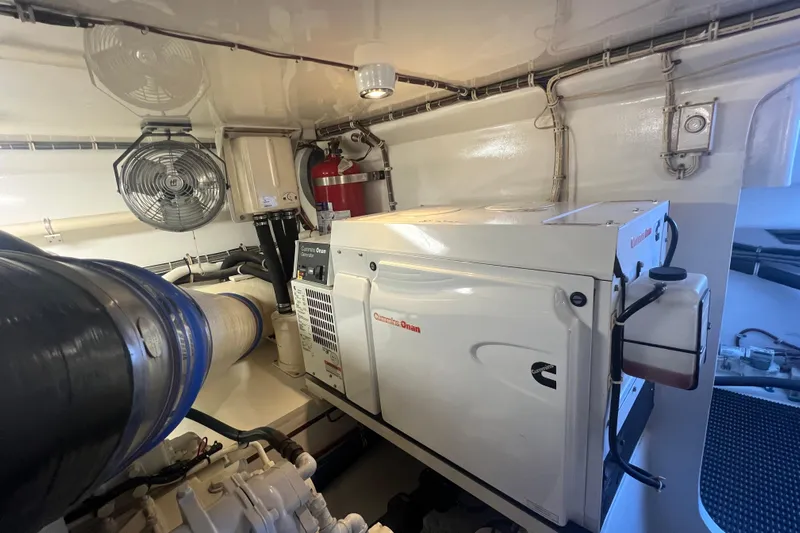 Sixpack Yacht Photos Pics Engine room of 2013 Hatteras GT63 yacht featuring Cummins Onan generator.