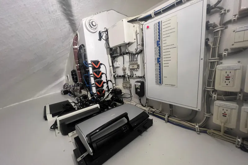 Sixpack Yacht Photos Pics Electrical control room of a 2013 Hatteras GT63 yacht, featuring panels and wiring.