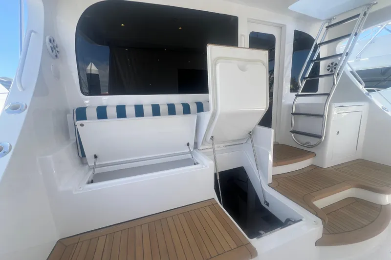 Sixpack Yacht Photos Pics 2013 Hatteras GT63 yacht interior with seating, storage, and ladder.