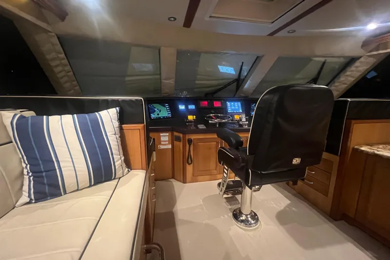 Sixpack Yacht Photos Pics Interior of 2013 Hatteras GT63 yacht cockpit with navigation controls and seating.