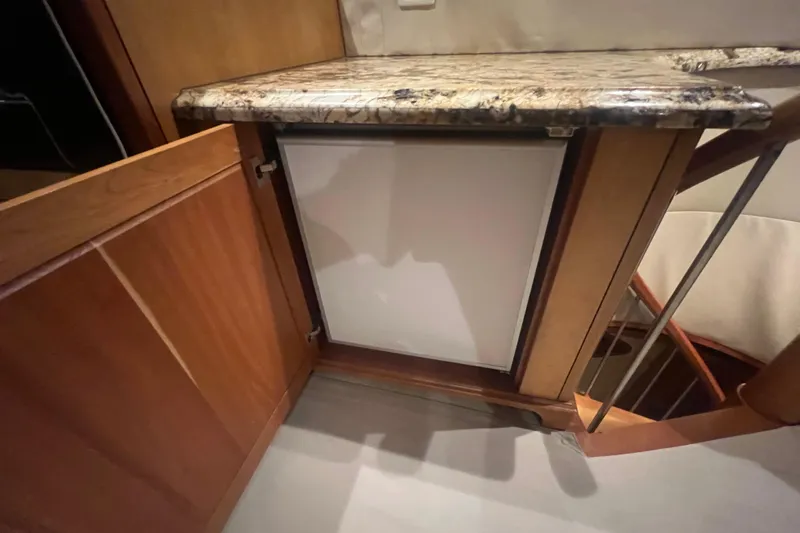 Sixpack Yacht Photos Pics Interior of 2013 Hatteras GT63 yacht with wooden cabinetry and granite countertop.