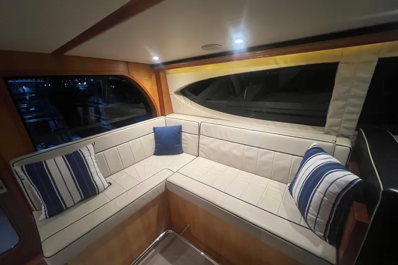 Sixpack Yacht Photos Pics Luxurious interior of 2013 Hatteras GT63 yacht with elegant seating and striped cushions.