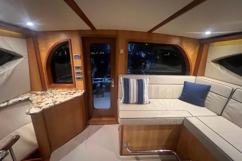 Sixpack Yacht Photos Pics Luxurious interior of 2013 Hatteras GT63 yacht with plush seating and elegant wood finishes.
