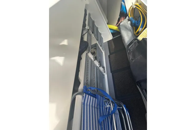 Lola Yacht Photos Pics Storage compartment on a 2019 Prestige 460 yacht with various equipment and accessories.