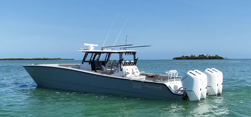  Yacht Photos Pics Freeman 47 boat, 2021 model, on calm water with island in background.