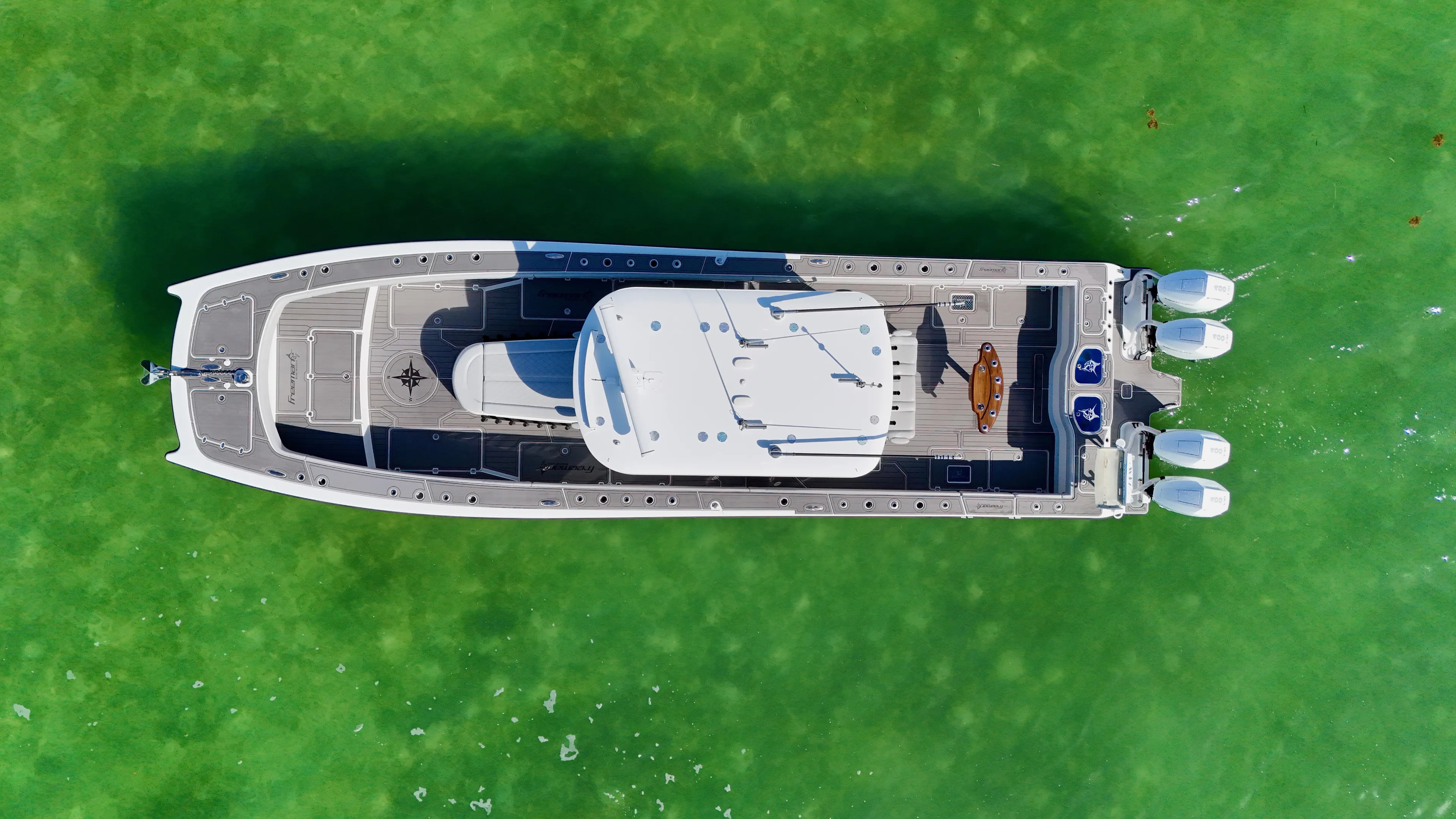  Yacht Photos Pics Aerial view of 2021 Freeman 47 boat on vibrant green water.