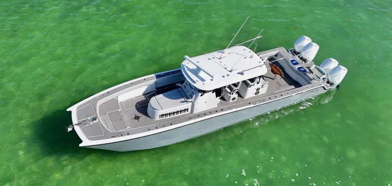  Yacht Photos Pics Aerial view of 2021 Freeman 47 boat on clear green water.