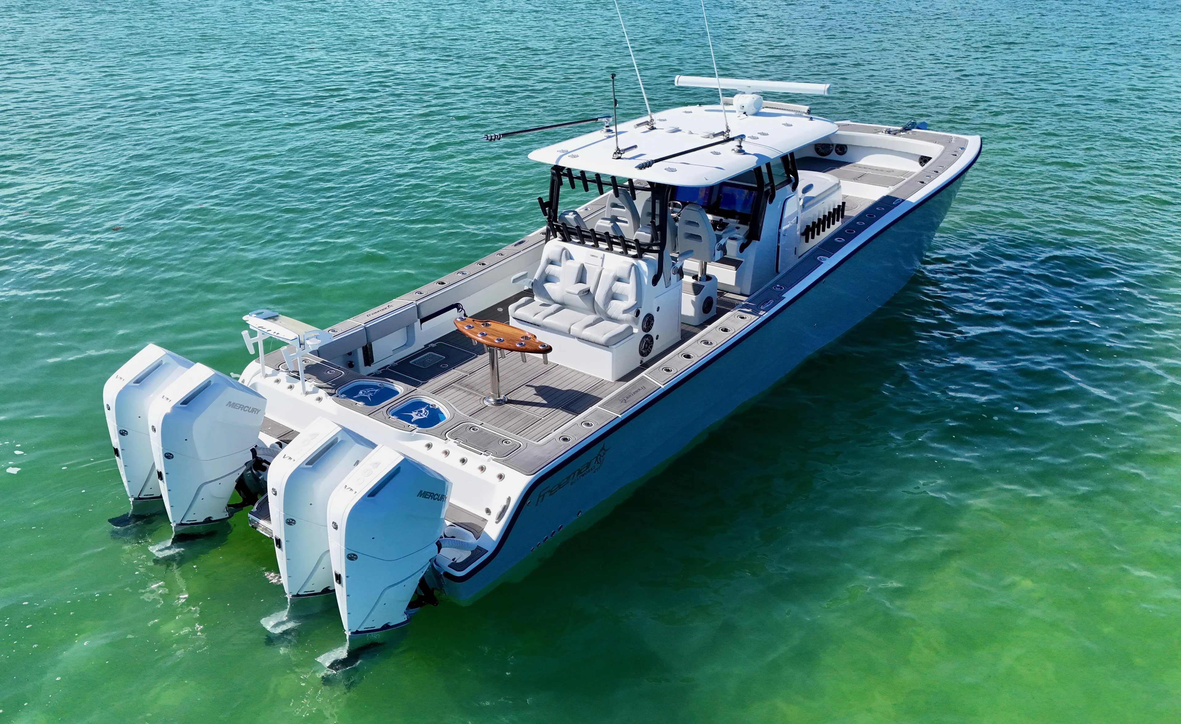  Yacht Photos Pics 2021 Freeman 47 boat on clear turquoise water, featuring dual outboard engines.