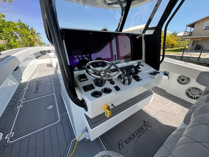  Yacht Photos Pics Interior of a 2021 Freeman 47 boat with modern steering console and seating.
