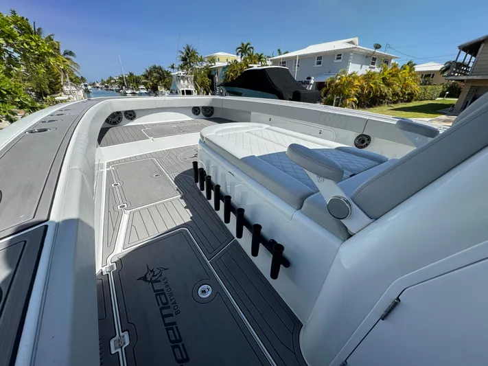  Yacht Photos Pics 2021 Freeman 47 boat with sleek seating and spacious deck in a sunny marina.