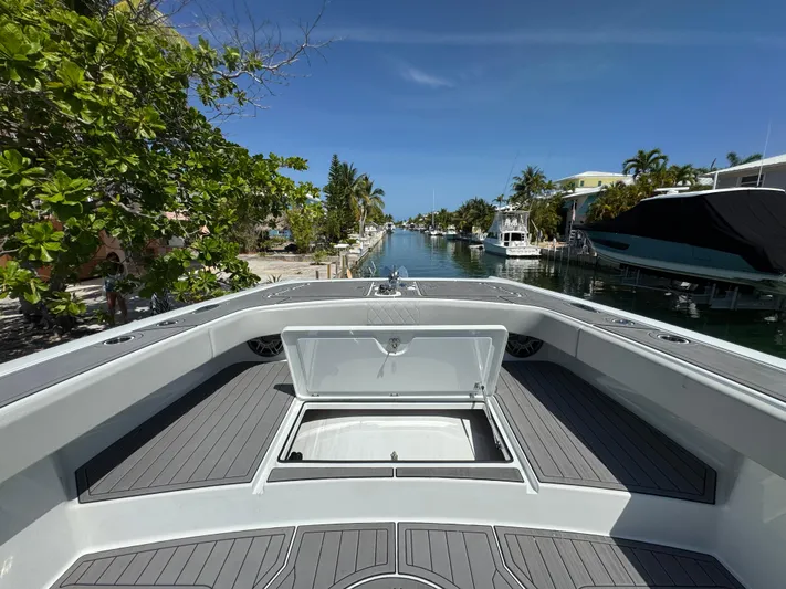  Yacht Photos Pics Freeman 47 boat deck view, open storage hatch, canal background, sunny day, 2021 model.