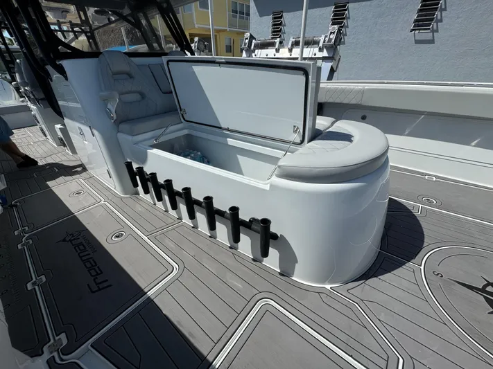  Yacht Photos Pics Freeman 47 boat interior with open storage compartment, rod holders, and cushioned seating, 2021 model.