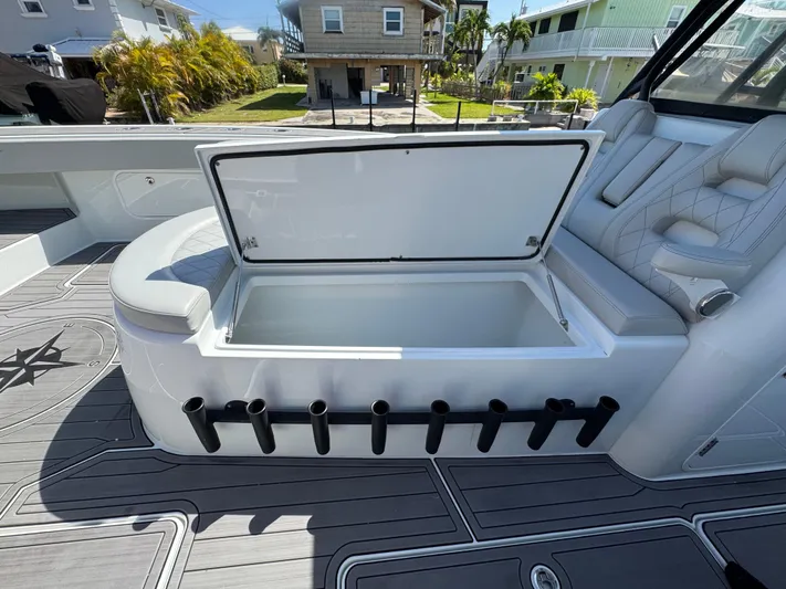  Yacht Photos Pics Open storage compartment on a 2021 Freeman 47 boat with rod holders and seating.