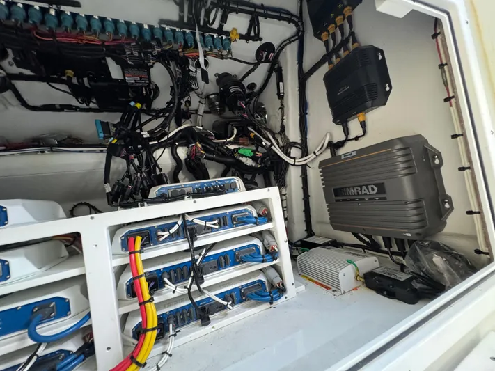  Yacht Photos Pics Electrical system inside a 2021 Freeman 47 boat, featuring Simrad equipment and organized wiring.