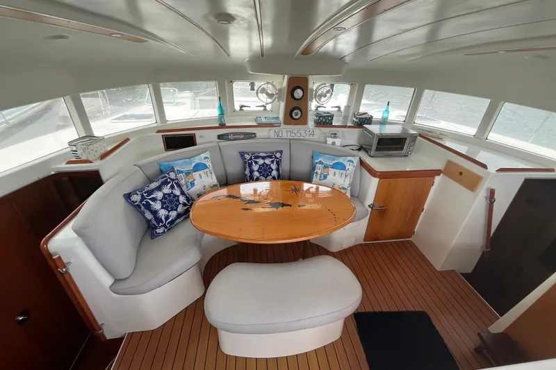 Namaste Yacht Photos Pics Interior of 2004 Lagoon 380 catamaran with cozy seating and nautical decor.