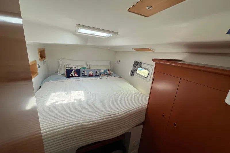 Namaste Yacht Photos Pics Cozy cabin interior of 2004 Lagoon 380 catamaran with nautical-themed decor.