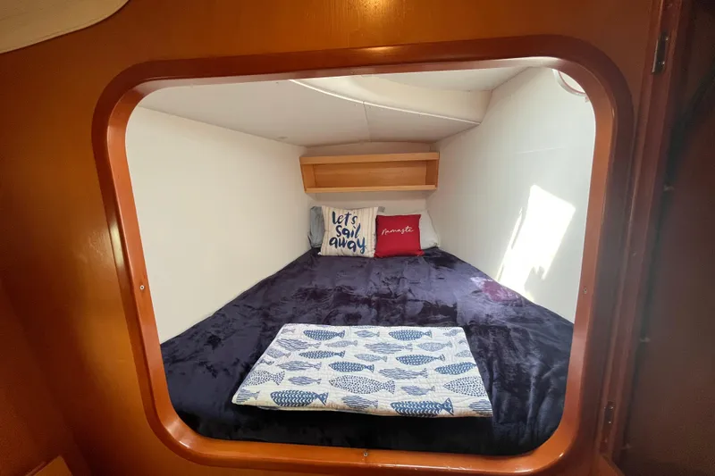 Namaste Yacht Photos Pics Cozy cabin interior of 2004 Lagoon 380 catamaran with nautical-themed bedding.
