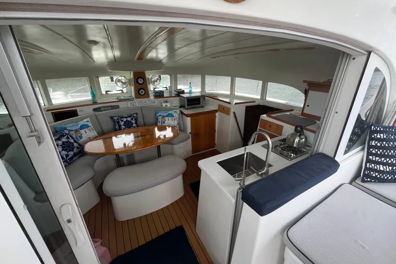 Namaste Yacht Photos Pics Interior of 2004 Lagoon 380 catamaran with cozy seating, kitchen, and dining area.