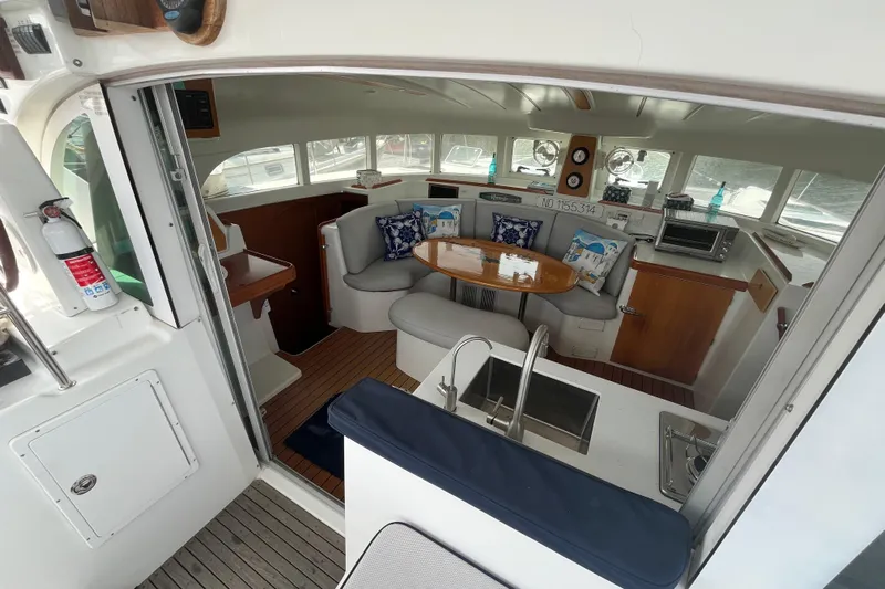 Namaste Yacht Photos Pics Interior of 2004 Lagoon 380 catamaran with cozy seating and dining area.