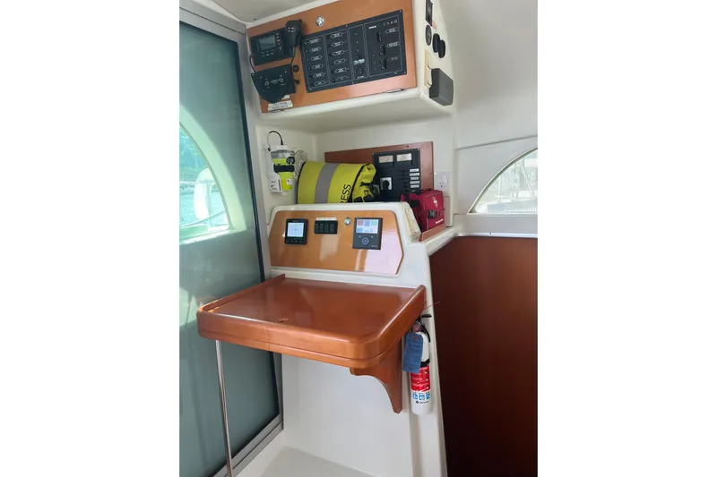 Namaste Yacht Photos Pics Navigation station of 2004 Lagoon 380 catamaran with control panels and safety equipment.