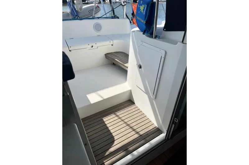 Namaste Yacht Photos Pics Interior view of 2004 Lagoon 380 catamaran, featuring wooden flooring and storage compartment.