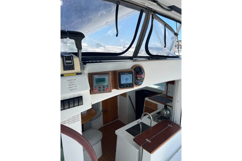 Namaste Yacht Photos Pics Interior view of 2004 Lagoon 380 catamaran cockpit with navigation instruments and kitchenette.