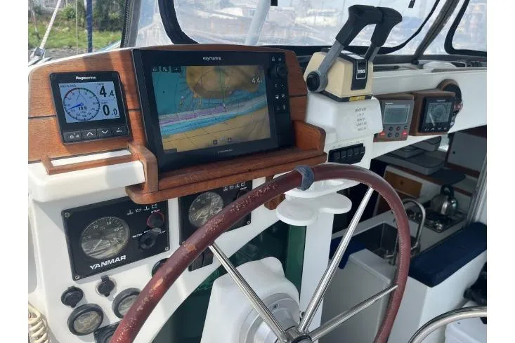 Namaste Yacht Photos Pics Cockpit of 2004 Lagoon 380 catamaran with navigation instruments and steering wheel.