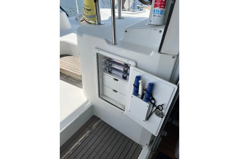 Namaste Yacht Photos Pics Storage compartment on 2004 Lagoon 380 catamaran with tools and safety equipment.