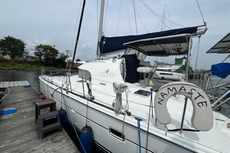 Namaste Yacht Photos Pics 2004 Lagoon 380 catamaran docked, featuring "Namaste" life ring and blue canopy.