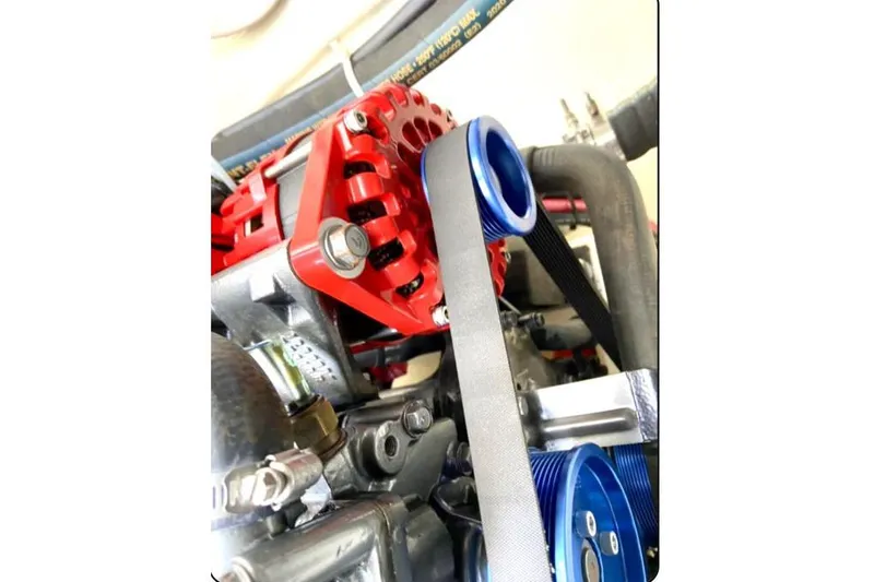 Namaste Yacht Photos Pics Close-up of a 2004 Lagoon 380 engine component with red and blue parts.