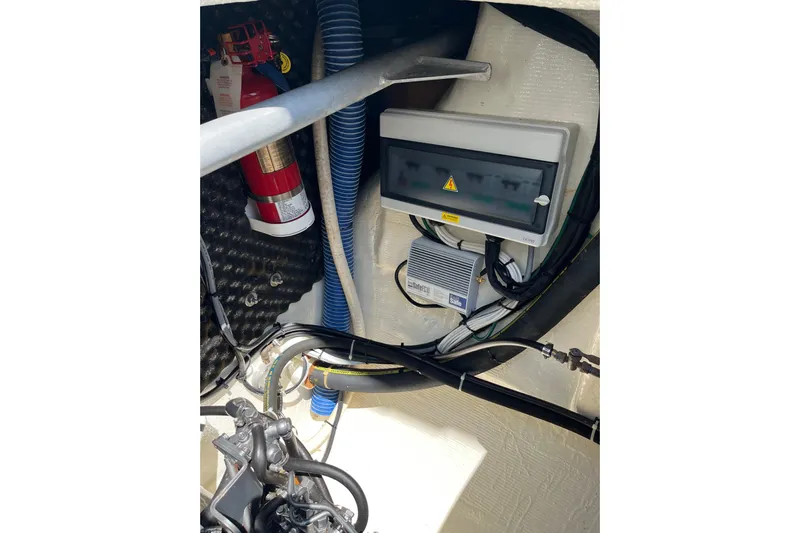 Namaste Yacht Photos Pics Electrical panel and fire extinguisher in 2004 Lagoon 380 boat engine compartment.