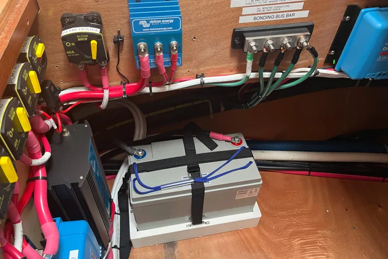 Namaste Yacht Photos Pics Electrical system setup in a 2004 Lagoon 380 catamaran, featuring battery and wiring components.