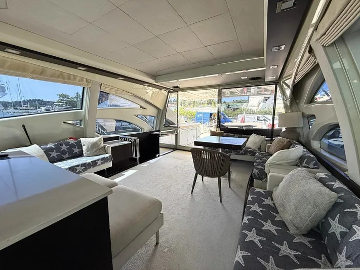  Yacht Photos Pics Luxurious interior of a 2006 Azimut 86S yacht with stylish seating and large windows.