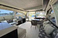 Luxurious interior of a 2006 Azimut 86S yacht with stylish seating and large windows.
