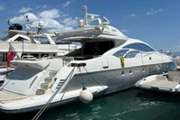 2006 Azimut 86S yacht docked at marina under clear blue sky.