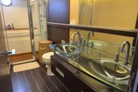 Luxurious bathroom in 2006 Azimut 86S yacht with modern glass sink and sleek design.
