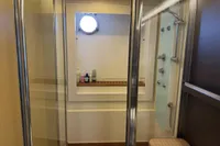 Luxurious bathroom on 2006 Azimut 86S yacht with modern shower and porthole window.
