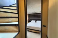 Interior view of 2006 Azimut 86S yacht showing stairs and bedroom.