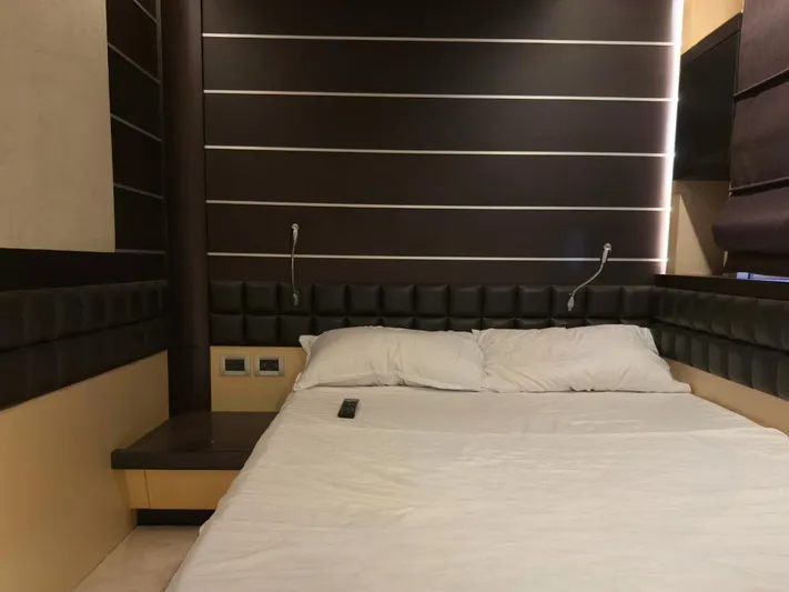  Yacht Photos Pics Luxurious bedroom interior on a 2006 Azimut 86S yacht, featuring modern design and cozy bedding.