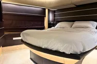 Luxurious bedroom interior of 2006 Azimut 86S yacht with modern design and cozy bedding.