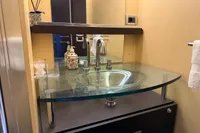 Luxurious bathroom sink with glass countertop in 2006 Azimut 86S yacht.