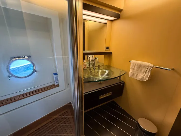  Yacht Photos Pics Luxurious bathroom in 2006 Azimut 86S yacht with glass sink and porthole window.