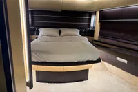Luxurious bedroom interior of a 2006 Azimut 86S yacht with modern design elements.