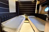 Luxurious twin bedroom in 2006 Azimut 86S yacht with modern design and ambient lighting.