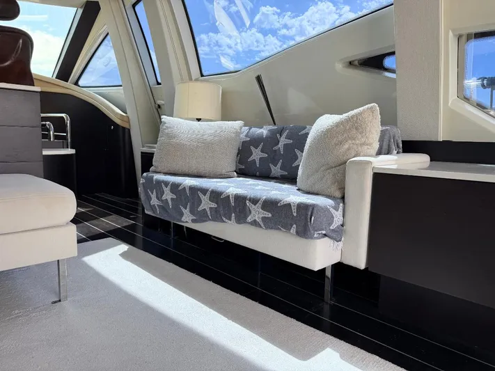  Yacht Photos Pics Interior of 2006 Azimut 86S yacht with cozy seating and star-patterned blanket.