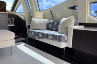 Interior of 2006 Azimut 86S yacht with cozy seating and star-patterned blanket.