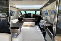 Luxurious interior of a 2006 Azimut 86S yacht with modern furnishings and ample natural light.