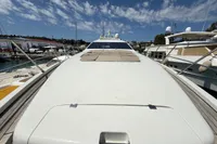 Luxury 2006 Azimut 86S yacht docked at marina under blue sky.
