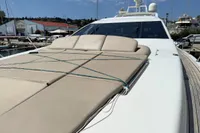 2006 Azimut 86S yacht with sunbathing deck, docked at marina under clear sky.